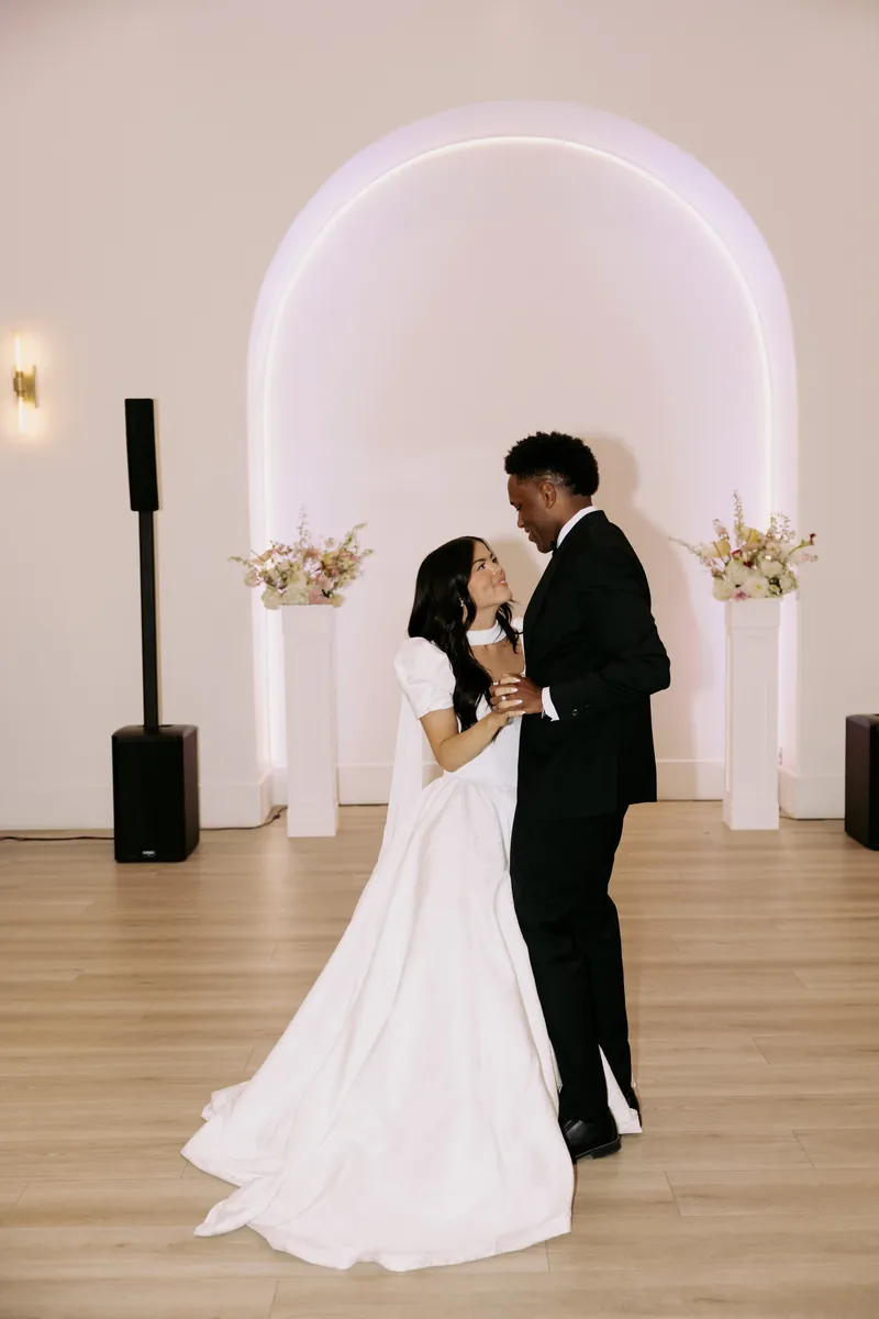 Couple's first dance under the lit arch at Moments on Main, Payson
