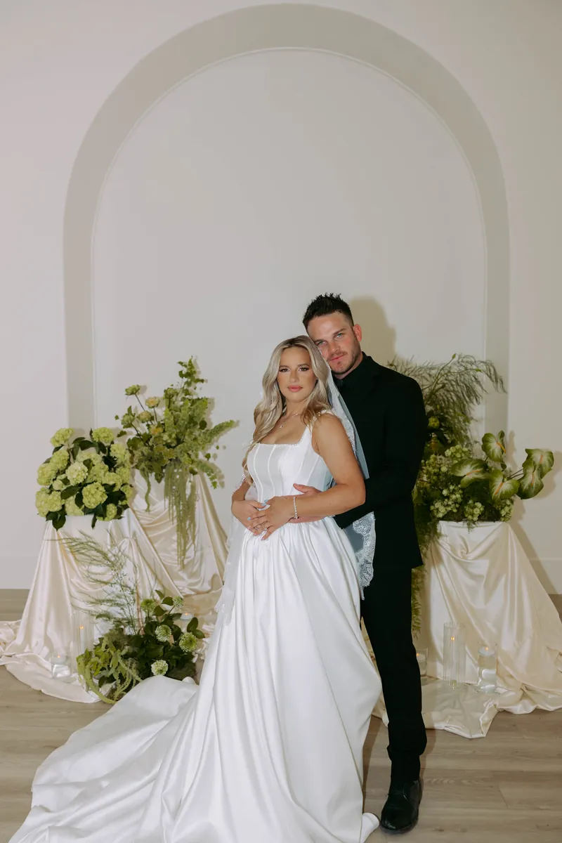 Bride and groom portrait with florals at Moments on Main wedding venue, Payson