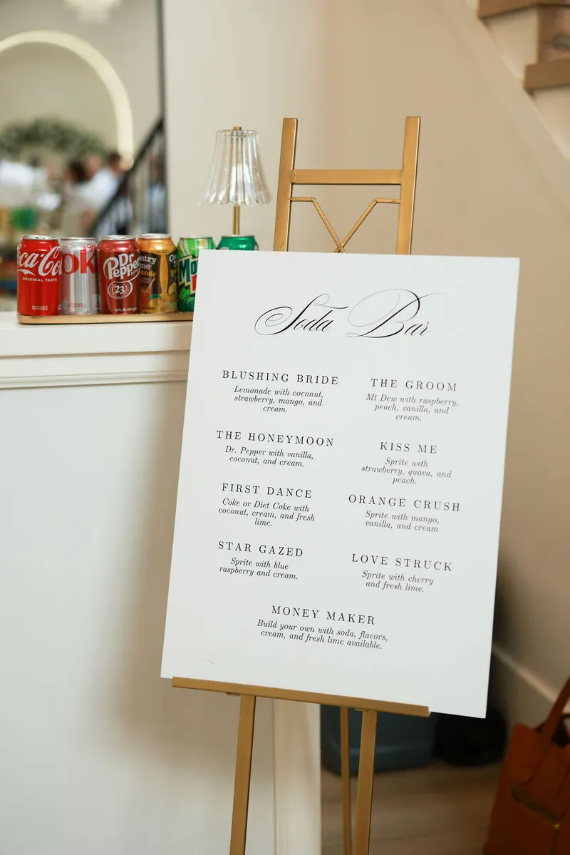 Soda bar menu sign on a gold easel at a Moments on Main wedding, Payson, Utah