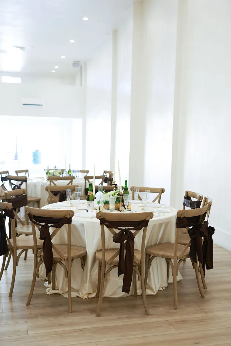 Round table with cross-back chairs set for dinner at Moments on Main, Payson
