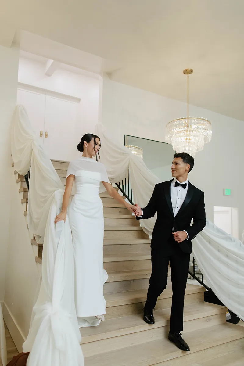 Bride and groom on the staircase at Moments on Main wedding venue, Payson