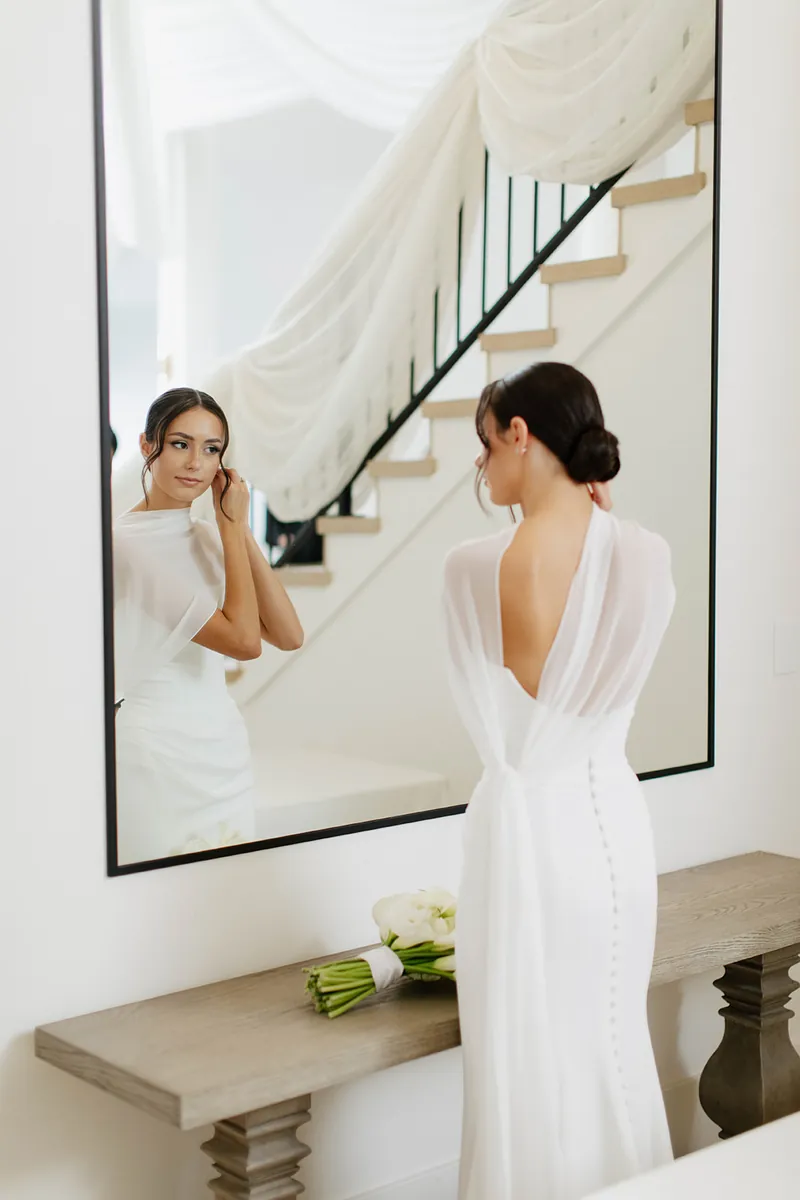 Bride at the mirror in the bridal suite at Moments on Main, Payson