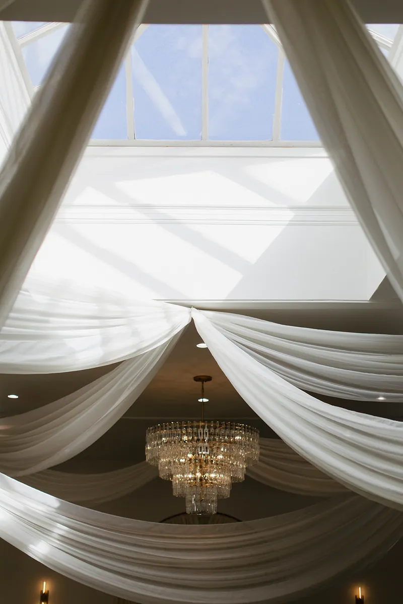 Skylight, draping, and chandelier detail at Moments on Main, Payson