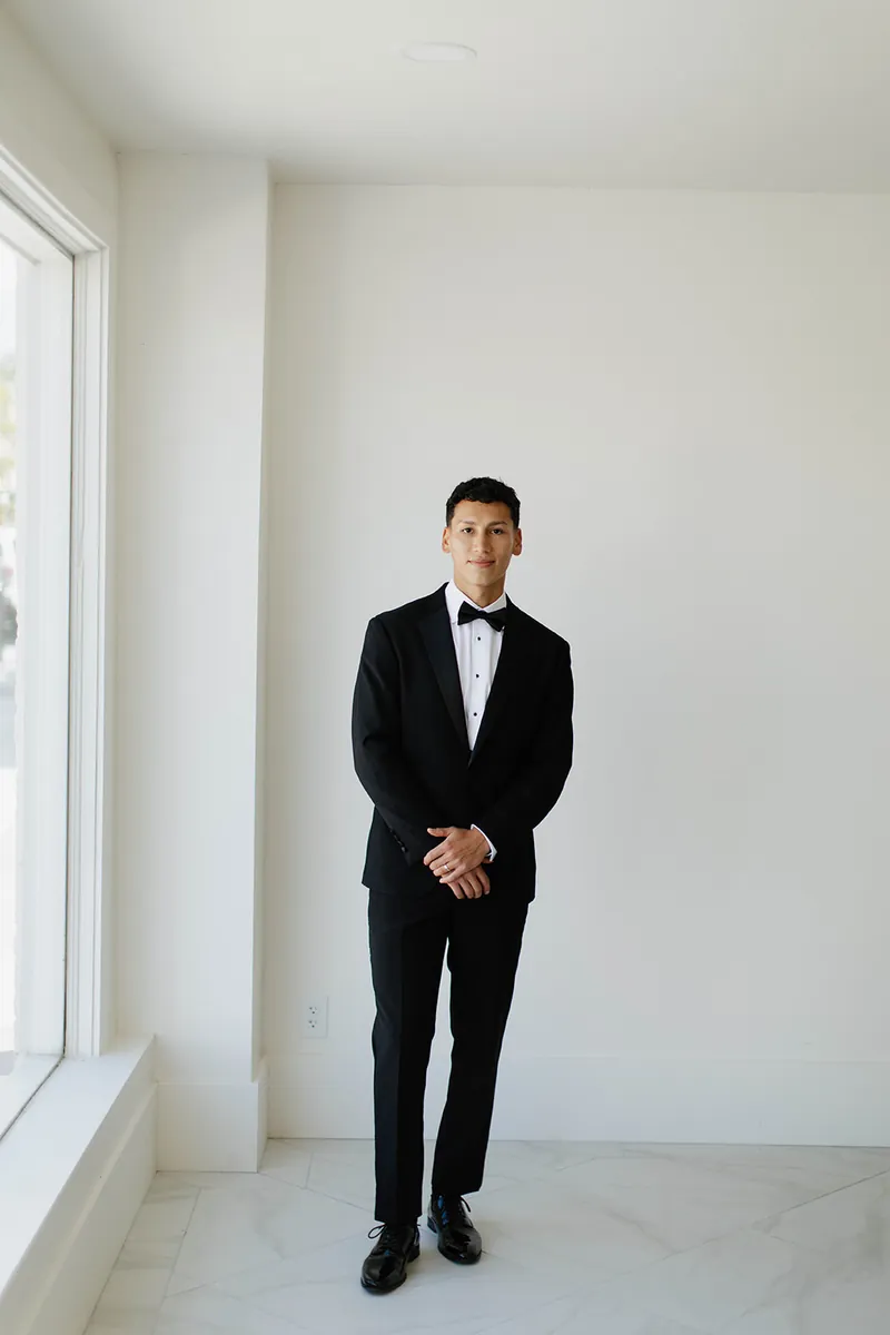 Groom by the front windows at Moments on Main, Payson