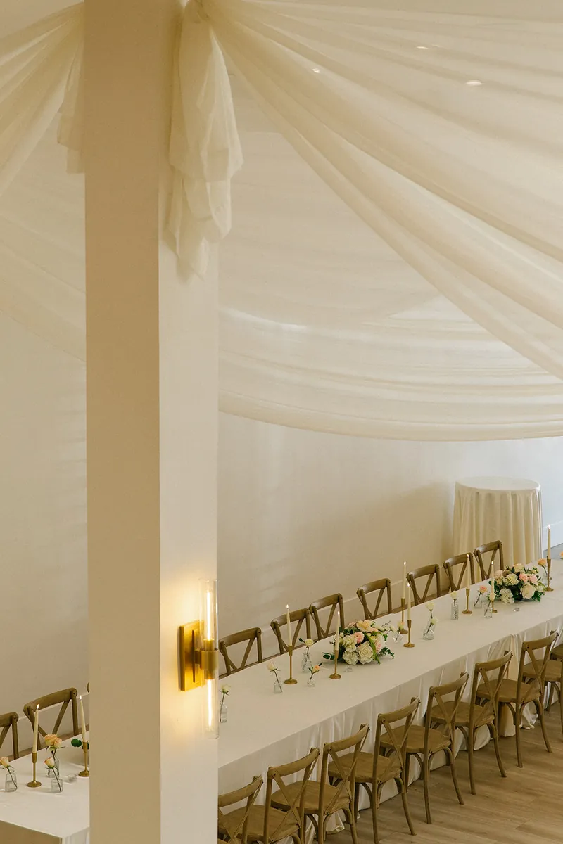 Long reception table viewed from the staircase at Moments on Main, Payson