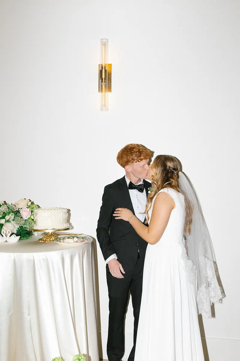 Bride and groom beside the cake table at Moments on Main, Payson