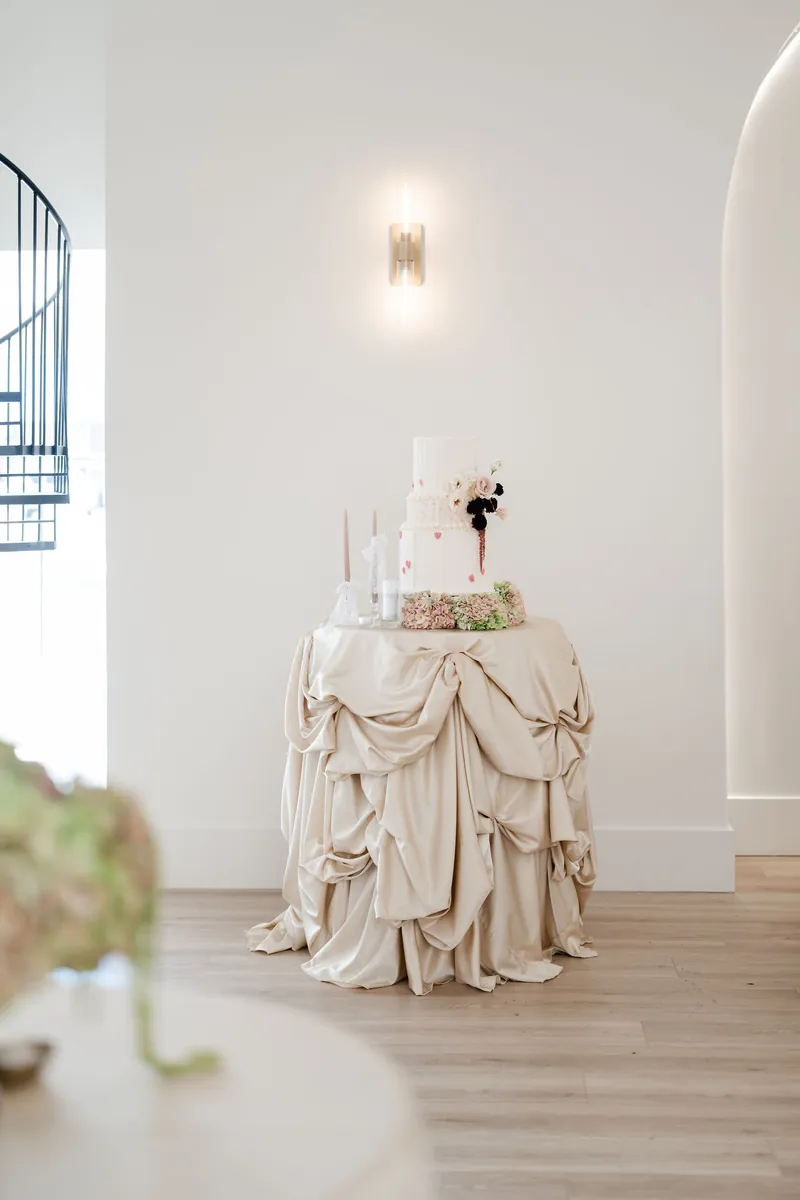 Cake table with draped linens at Moments on Main, Payson