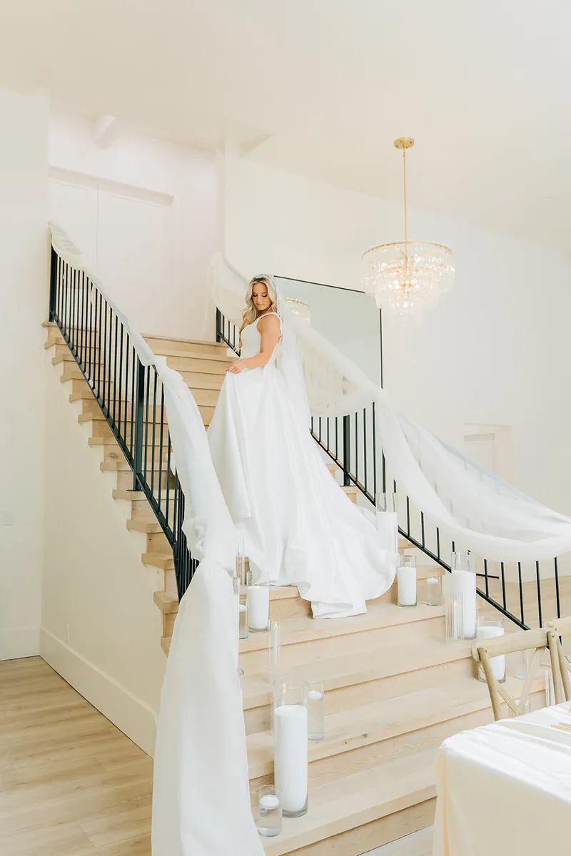 Bride on the staircase at Moments on Main wedding venue, Payson, Utah