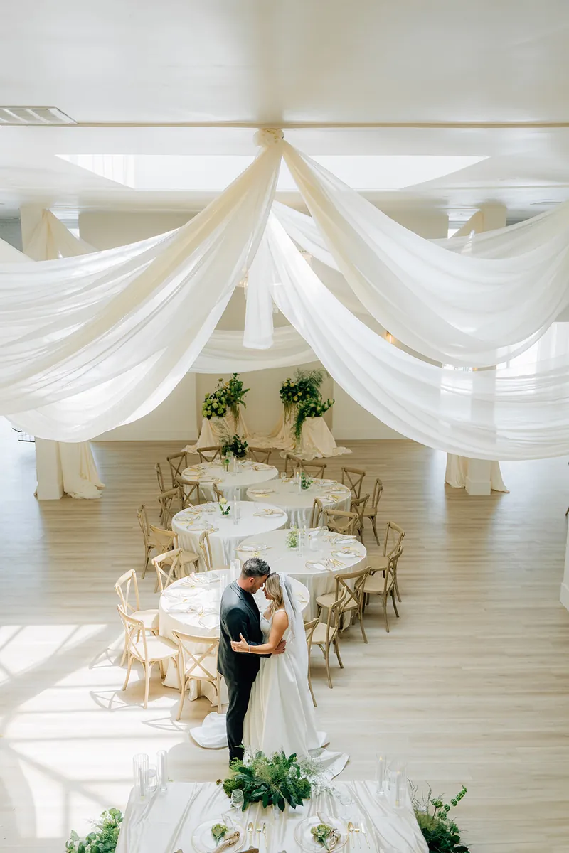 Couple among set tables seen from the staircase at Moments on Main