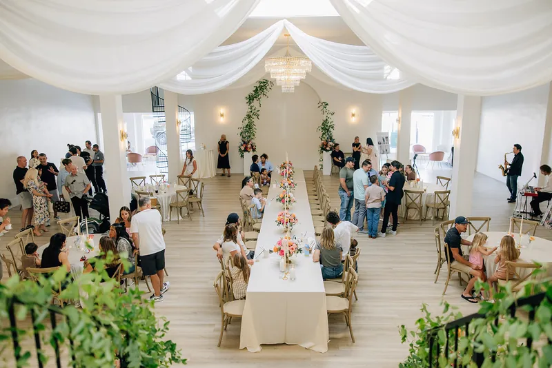 Guests gathered at long tables in the main room at Moments on Main, Payson, Utah