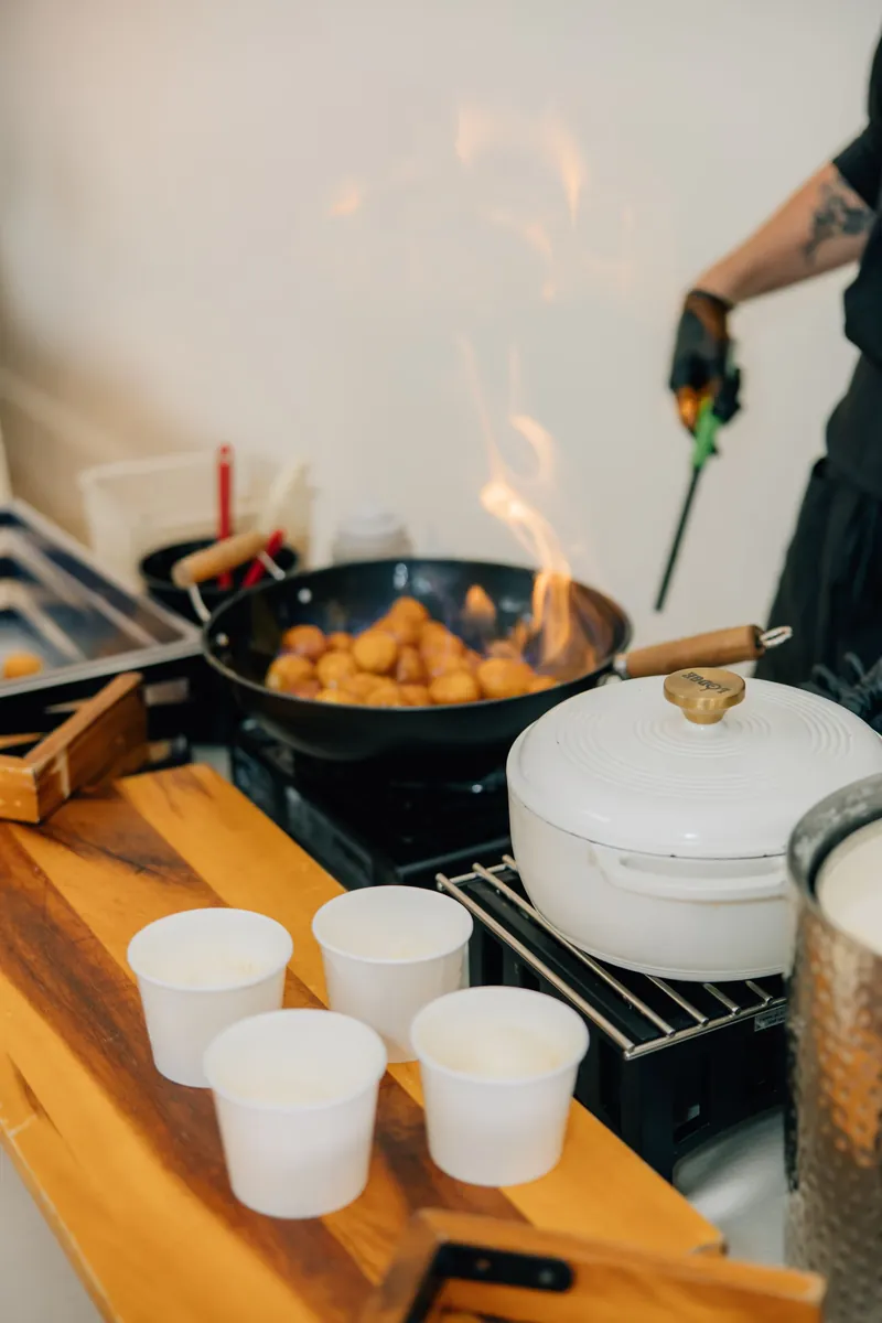 Mini donuts frying in a pan beside serving cups at a Moments on Main event, Payson, Utah